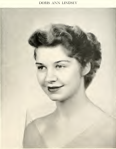 A black and white image of Doris Ann Lindsey. Her wavy hair is pulled back into a bun. The image shows her from the shoulders up. 